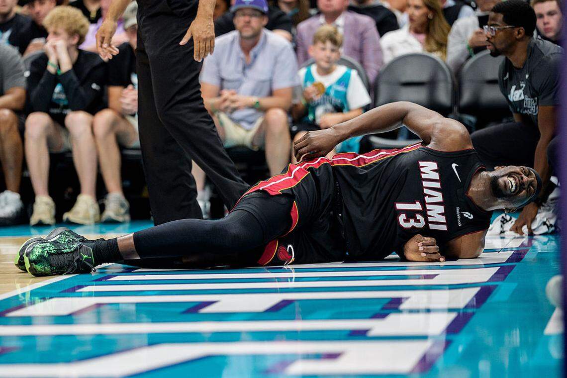 Bam Adebayo #13 of the Miami Heat reacts after a fall in the first half against the Charlotte Hornets during their game at Spectrum Center on April 14, 2026 in Charlotte, North Carolina.