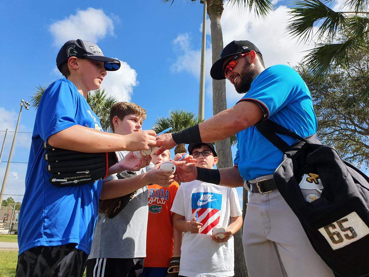 Miami Marlins infielder Eddy Alvarez signs autographs during spring training on Tuesday, Feb. 18, 2020, at the Roger Dean Chevrolet Stadium complex in Jupiter, Florida.