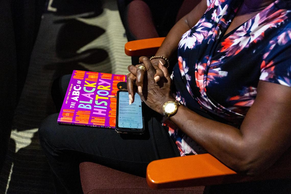 A woman holds the book, ‘The ABC’s of Black History’ during a town hall regarding the state’s newly adopted curriculum standards on African-American history at Antioch Missionary Baptist Church in Miami Gardens, Florida, on Thursday, Aug. 10, 2023.
