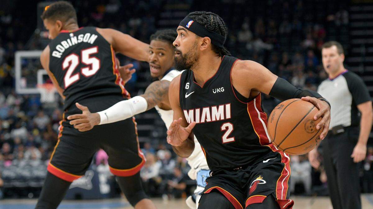 Miami Heat guard Gabe Vincent (2) handles the ball ahead of Memphis Grizzlies guard Ja Morant in the first half of a preseason NBA basketball game Friday, Oct. 7, 2022, in Memphis, Tenn.