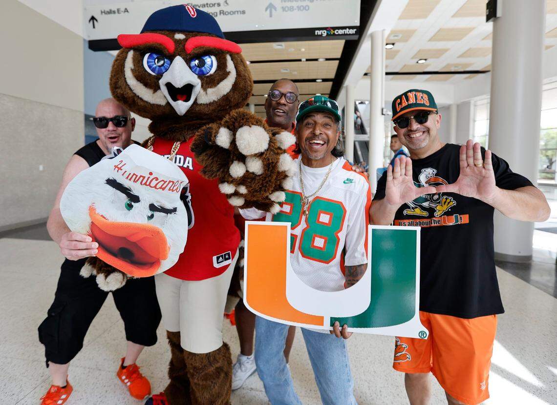 University of Miami fans Travis Small, Kevin Clark, Freddie Vasquez, George Leguizamo, pose for the picture with Florida Atlantic Owls mascot Owlsley before the start of the Men’s Basketball Championship National Semifinal between Florida Atlantic Owls against the San Diego State Aztecs at NRG Stadium in Houston, Texas on Saturday, April 1, 2023.