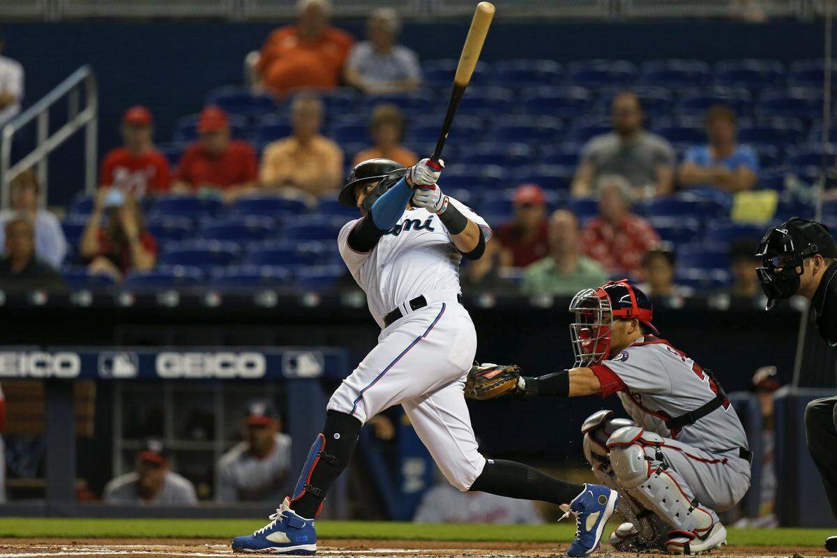 Miami Marlins shortstop Miguel Rojas (19) hits a double during the first inning of an Major League Baseball game against the Washington Nationals at Marlins Park in Miami on Thursday, June 27, 2019.