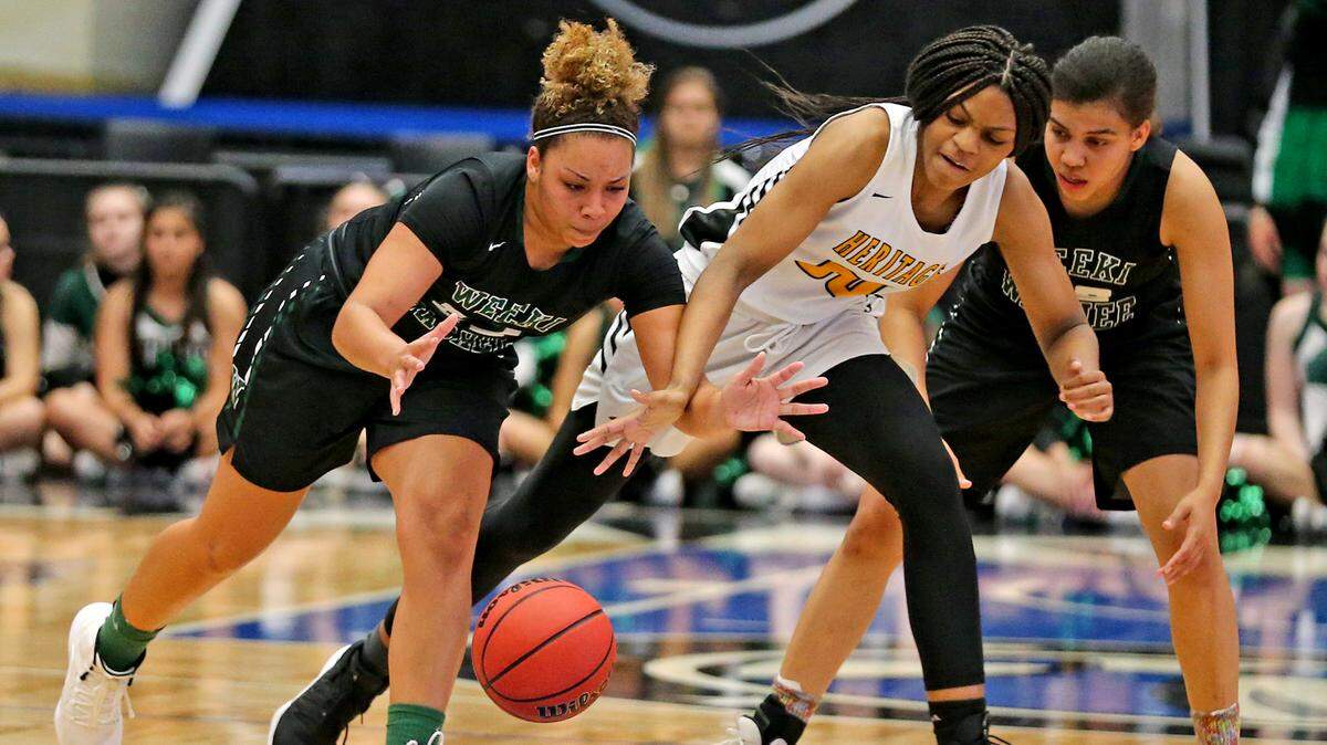 American Heritage Taliyah Wyche (00) and Weekie Wachee Seytia Hill (22) chase the ball in the 6A Semi-Finals Girl’s State Basketball Championships at the RP Funding Center in Lakeland, Florida, Wednesday, February, 27, 2019.