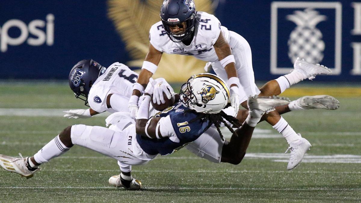 FIU Panthers wide receiver Randall St. Felix (16) is tackled by Old Dominion Monarchs defenders during football game Saturday, Nov. 6, 2021 at Riccardo Silva Stadium in Miami. Andrew Uloza / for THE MIAMI HERALD