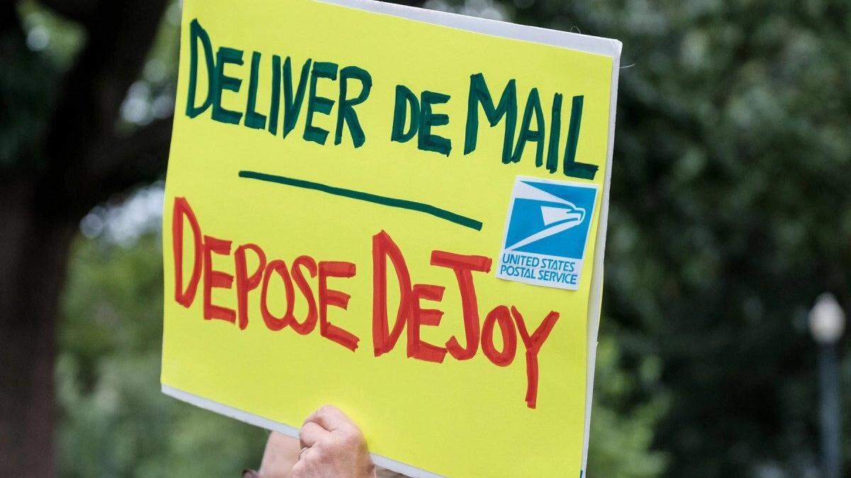 In August, demonstrators in Washington, D.C., protest the actions of U.S. Postmaster General Louis Dejoy.