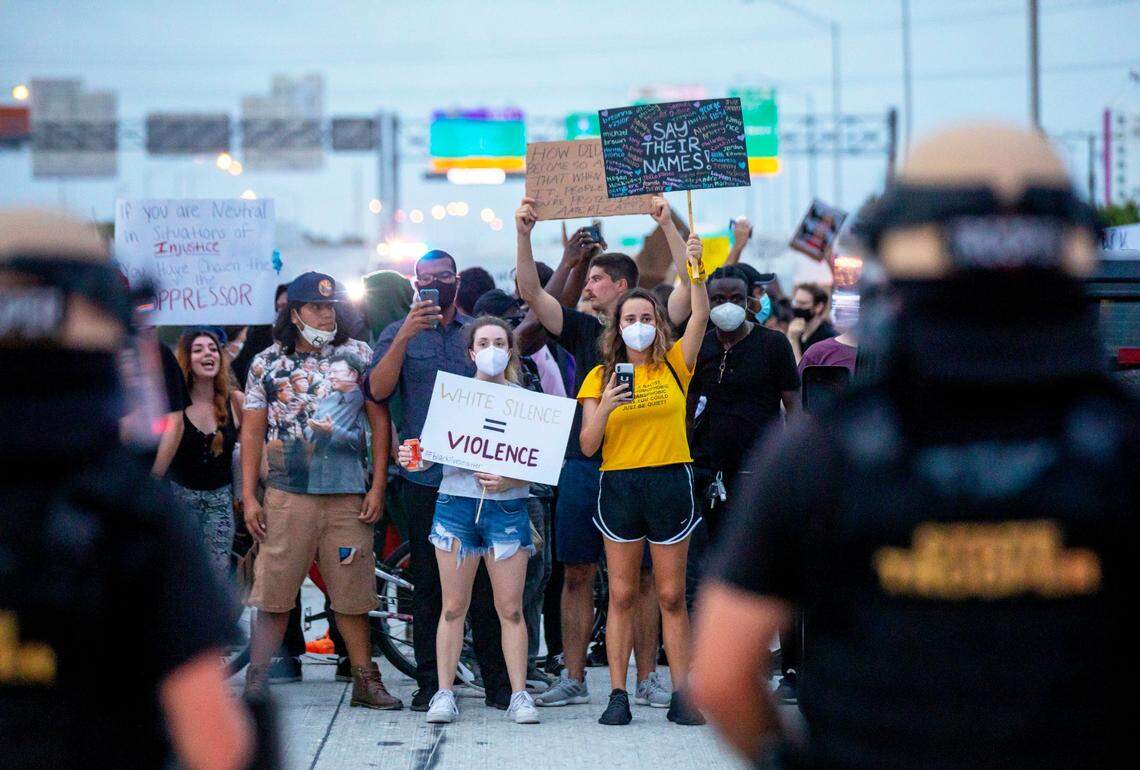 Florida State Troopers dressed in riot gear block and contain protesters blocking I-95 North after they broke through fencing from NW 26th Street, during a “Justice for George Floyd” protest that started in Wynwood on Friday, June 5, 2020.
