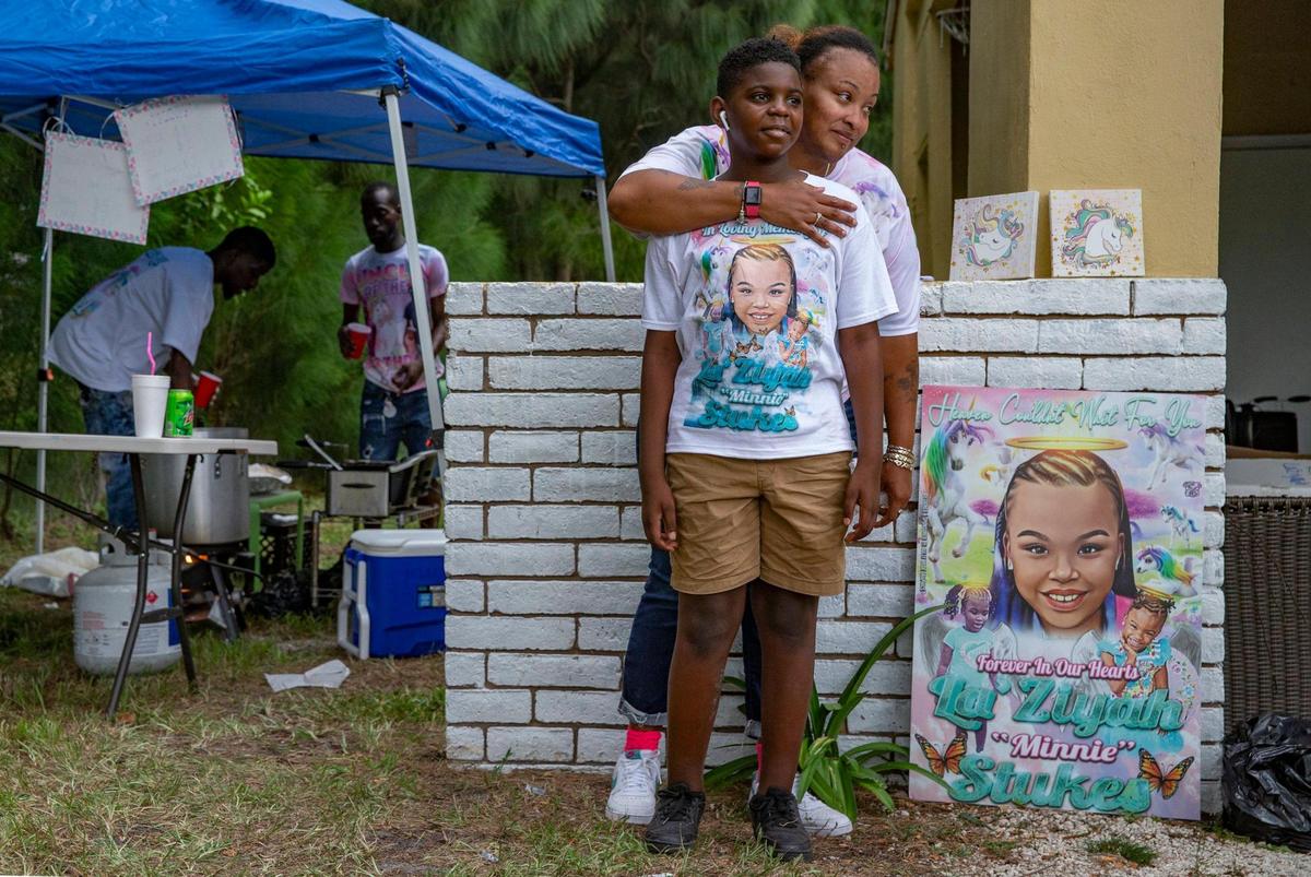 Seven months after a tragic hit-and-run that killed Laziyah Stukes, 10, and two other girls and left several children injured, Laziyah’s mother, Devera Stukes, holds a balloon release and fish fry to help raise money to pay for her daughter’s funeral. Devera Stukes stands with her godson Johnathan Carter, 11, by a poster of Laziyah “Minnie” Stukes, as family and friends gather at the Fort Lauderdale home on Saturday, July 16, 2022.