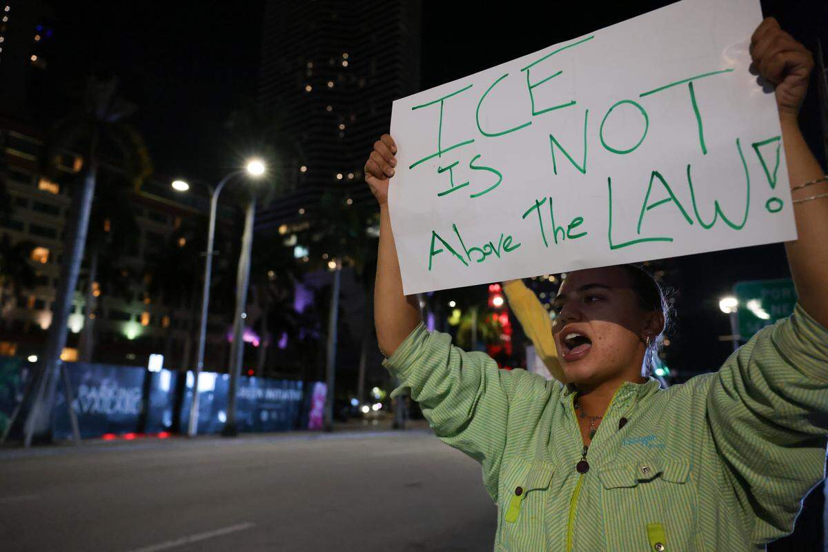 Lilly M protests against ICE at the Torch of Friendship monument at 401 Biscayne Blvd., in downtown Miami on Wednesday, Jan. 7, 2026.