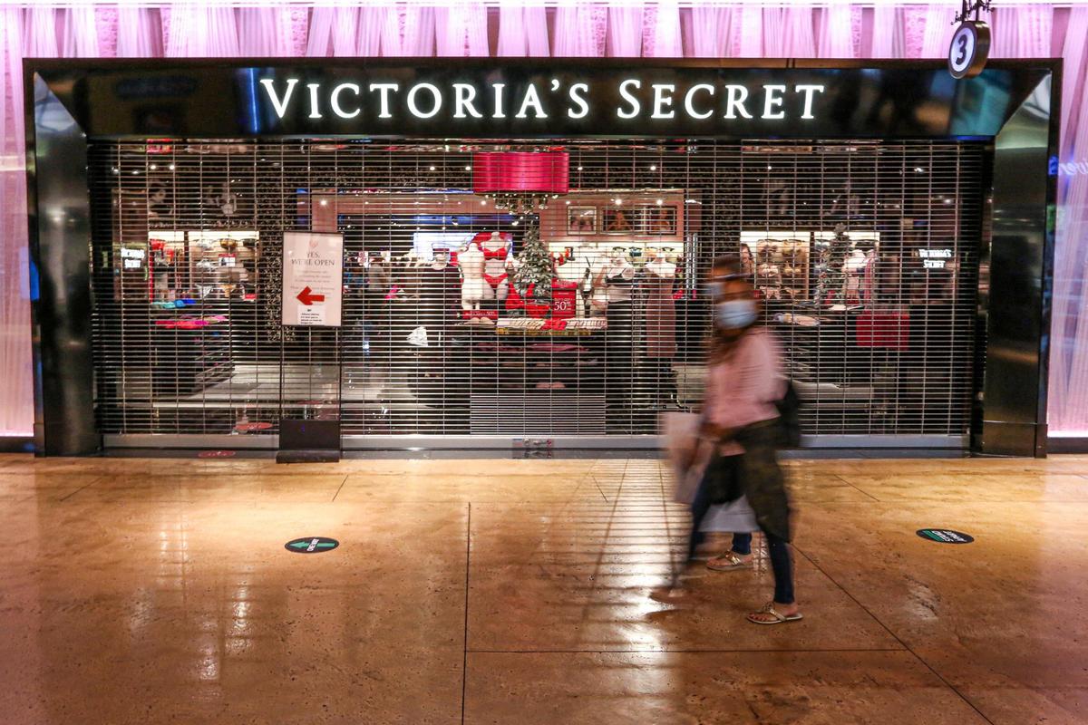 Shoppers walk by a closed entrance to the Victoria’s Secret store in an effort to control the number of people allowed inside during Black Friday shopping at Dolphin Mall in Sweetwater, Florida, on Nov. 27, 2020.