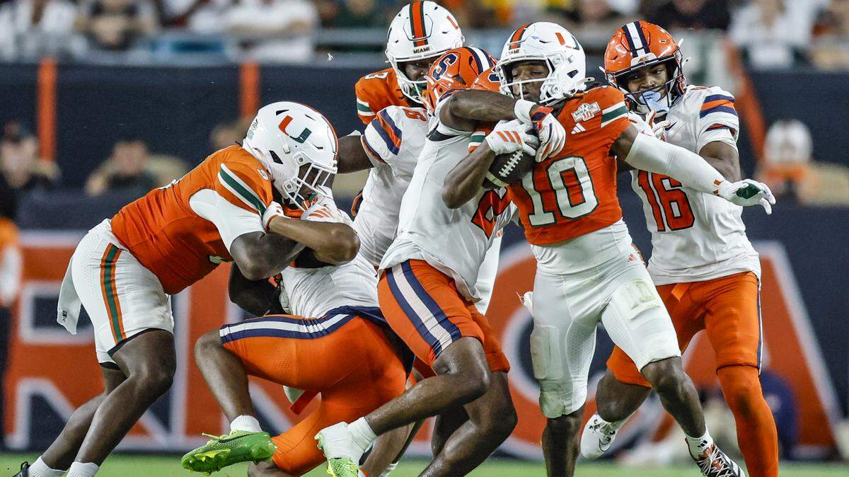 Miami Hurricanes wide receiver Malachi Toney (10) earns a first down as Syracuse Orange cornerback Duce Chestnut (2) attempts to make the stop in the second half of an NCAA football game at Hard Rock Stadium in Miami Gardens, Florida on Saturday, November 8, 2025.