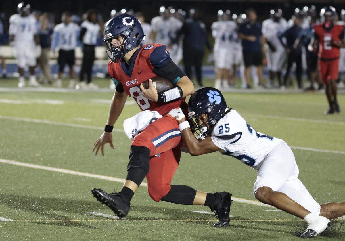 Columbus Explorer High's quarterback Kingston Rust (8) scrambles on an 38 yard run as Miami Palmetto High's Willie Dannah (25) makes the stop in the first half at Tropical Park in Miami, Florida on Friday, September 12, 2025.