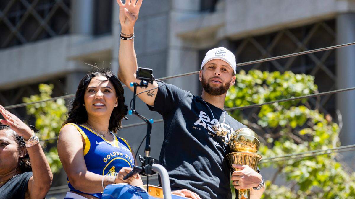 Golden State Warriors’ Stephen Curry accompanied by his wife Ayesha, left, holds the Larry O’Brien trophy during the NBA Championship parade in San Francisco, Monday, June 20, 2022, in San Francisco.
