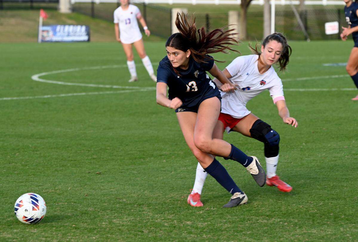 Palmer Trinity senior Brooklyn Schiffrin fights for a loose ball with King’s Academy senior Sofia Cueto during the FHSAA Class 2A girls soccer state championship game on Wednsesday at Lake Myrtle Sports Complex in Auburndale