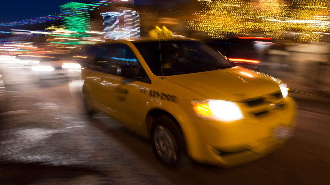 In this photo, a taxi drives on Main Street during the Sundance Film Festival on Thursday, Jan. 16, 2014, in Park City, Utah. Parents left a sleeping 4-year-old in a taxi after being driven home from a Boston Airport, police said. The taxi driver also left the child and parked the cab.