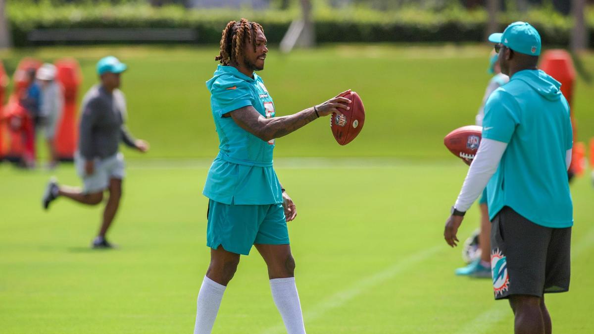 Miami Dolphins cornerback Jalen Ramsey (5) walks on the field with a football during training camp at Baptist Health Training Facility in Miami Gardens, Florida, Thursday, July 27, 2023.