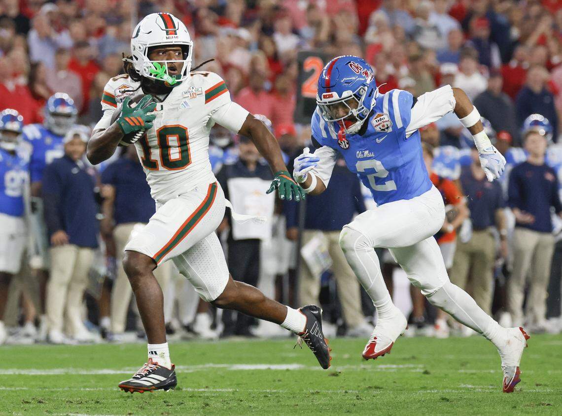 Miami Hurricanes wide receiver Malachi Toney (10) carries the ball for a touchdown as Mississippi Rebels cornerback Jaylon Braxton (2) gives chase during the second half of a College Football Playoff semifinal in the Fiesta Bowl at State Farm Stadium on Thursday, January 8, 2026 in Glendale, Arizona.