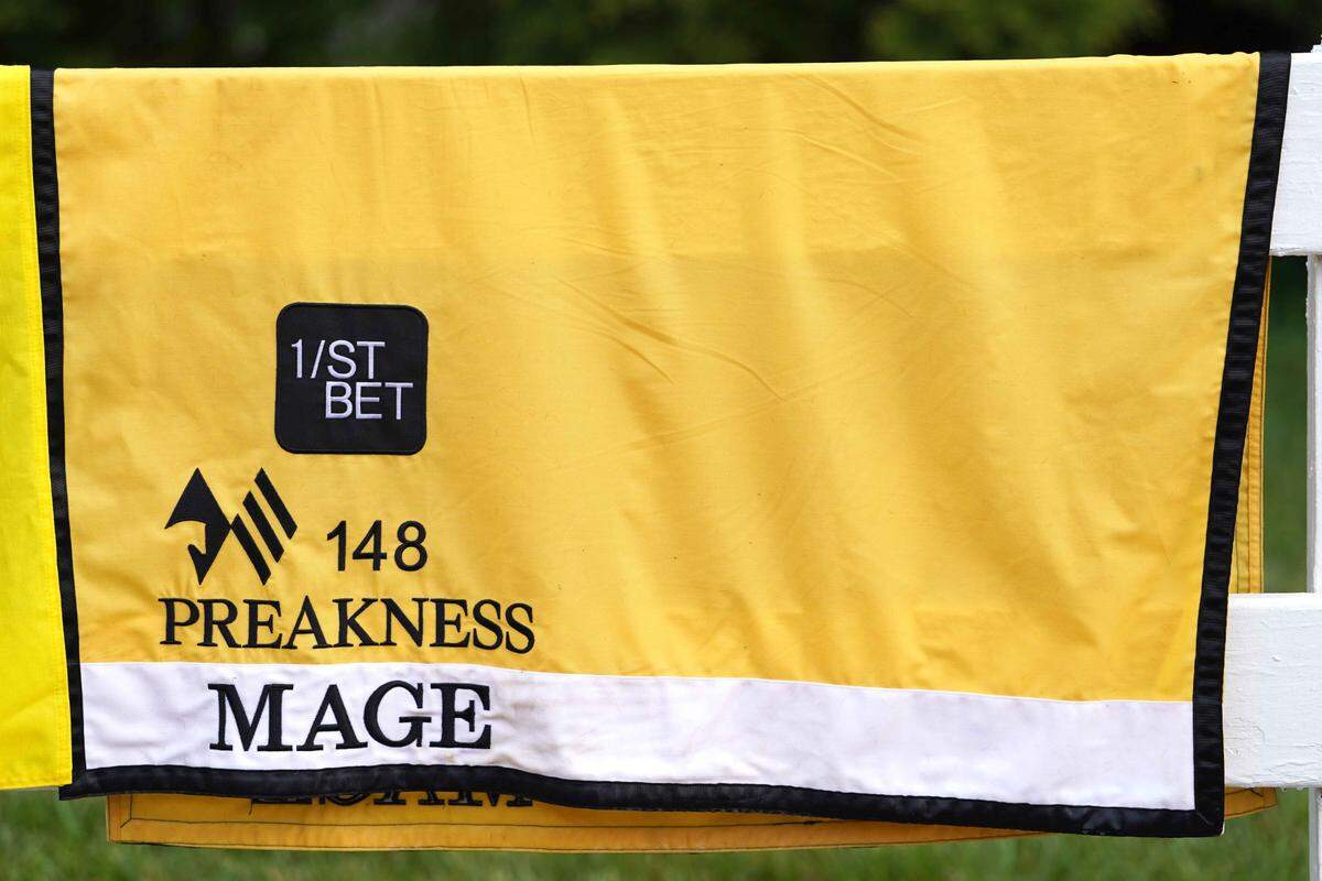 May 19, 2023; Baltimore, Maryland, USA; The saddle blanket for Mage dries on a fence near the Preakness Stakes barn following morning workouts at Pimlico Race Course. Mandatory Credit: Mitch Stringer-USA TODAY Sports