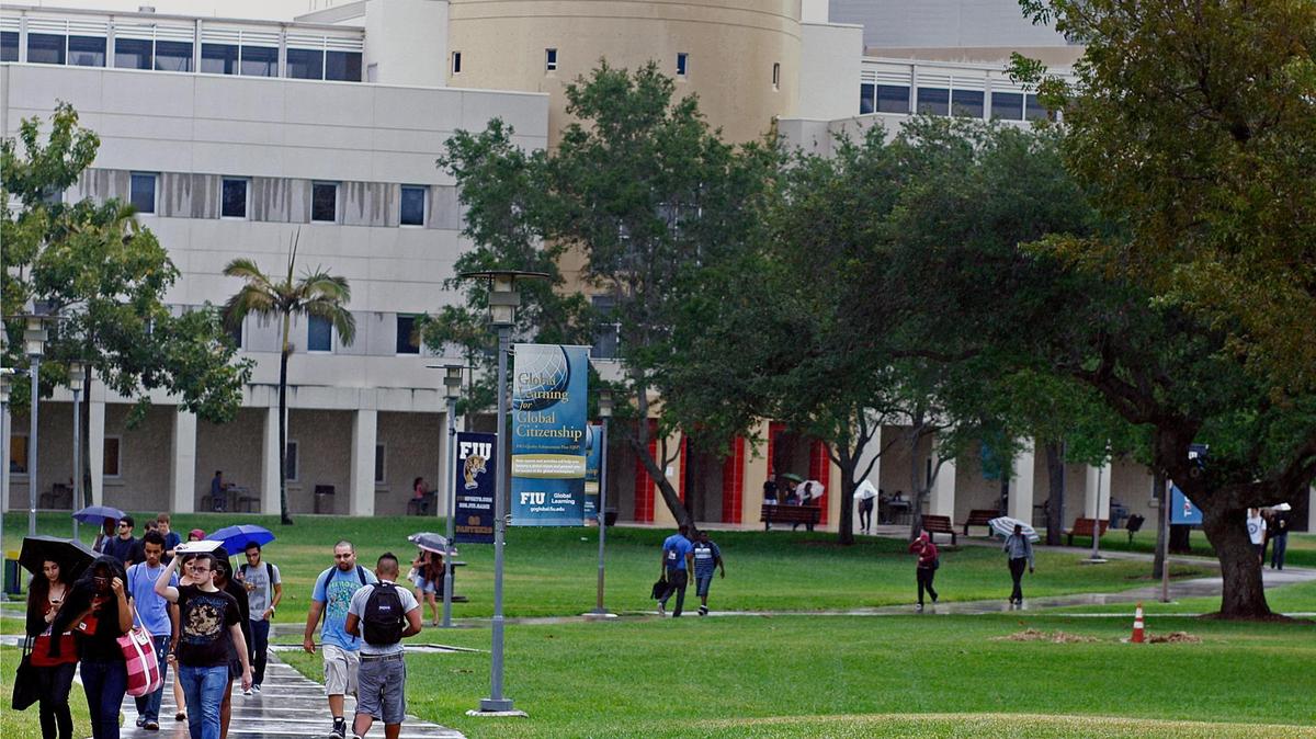 FIU students walk through the FIU Tamiami campus under light rain towards Graham Center building on Tuesday, March 29, 2011.