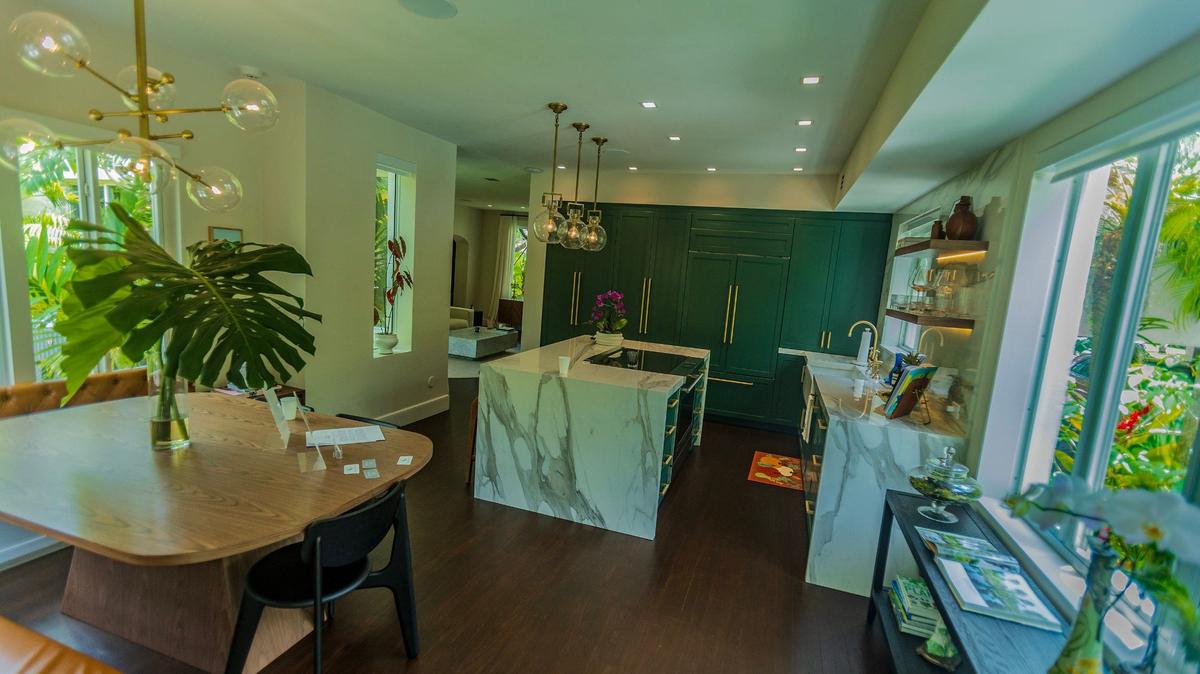 In Miami Shores, owners Russ Colombo and Alain Carrazana renovated their kitchen during the pandemic, pictured above. They hired designer Lissandra Castillo of 21 Design + Construction to lead the project. Formerly a dining room with tile flooring, the couple used original wood flooring from their master suite to give a seamless look from the living room into the kitchen.