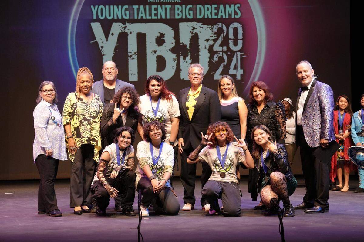 Young Talent Big Dreams 2024 Group Musical Instrument/Bands winner The Atomic Lollipops pose on stage with the four finals judges, Actors’ Playhouse and The Children’s Trust presenters, and host of the competition, Earl Maulding (far left.) The finales were held at Actors’ Playhouse at the Miracle Theatre in Coral Gables on May 11, 2024.