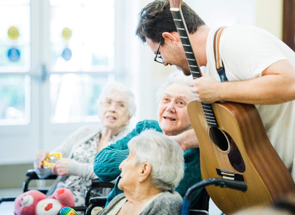 A guitarist with Mind and Melody entertains residents at The Palace, a skilled nursing facility and rehab center in west Miami-Dade.