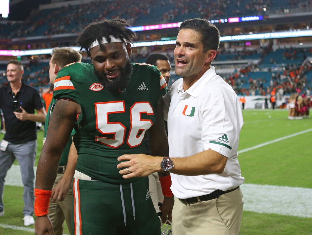 Miami Hurricanes linebacker Michael Pinckney and Manny Diaz celebrate their 28-27 win over Florida last season. Diaz is now the head coach, but was the defensive coordinator back then.