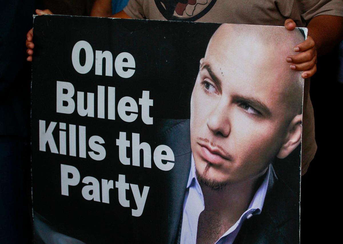 A closer look at a poster from a prior year’s campaign featuring Miami performer Pitbull and the slogan “One Bullet Kills the Party.” The event was held on Monday, Dec. 30, 2019, at Olinda Park in Miami, Florida.