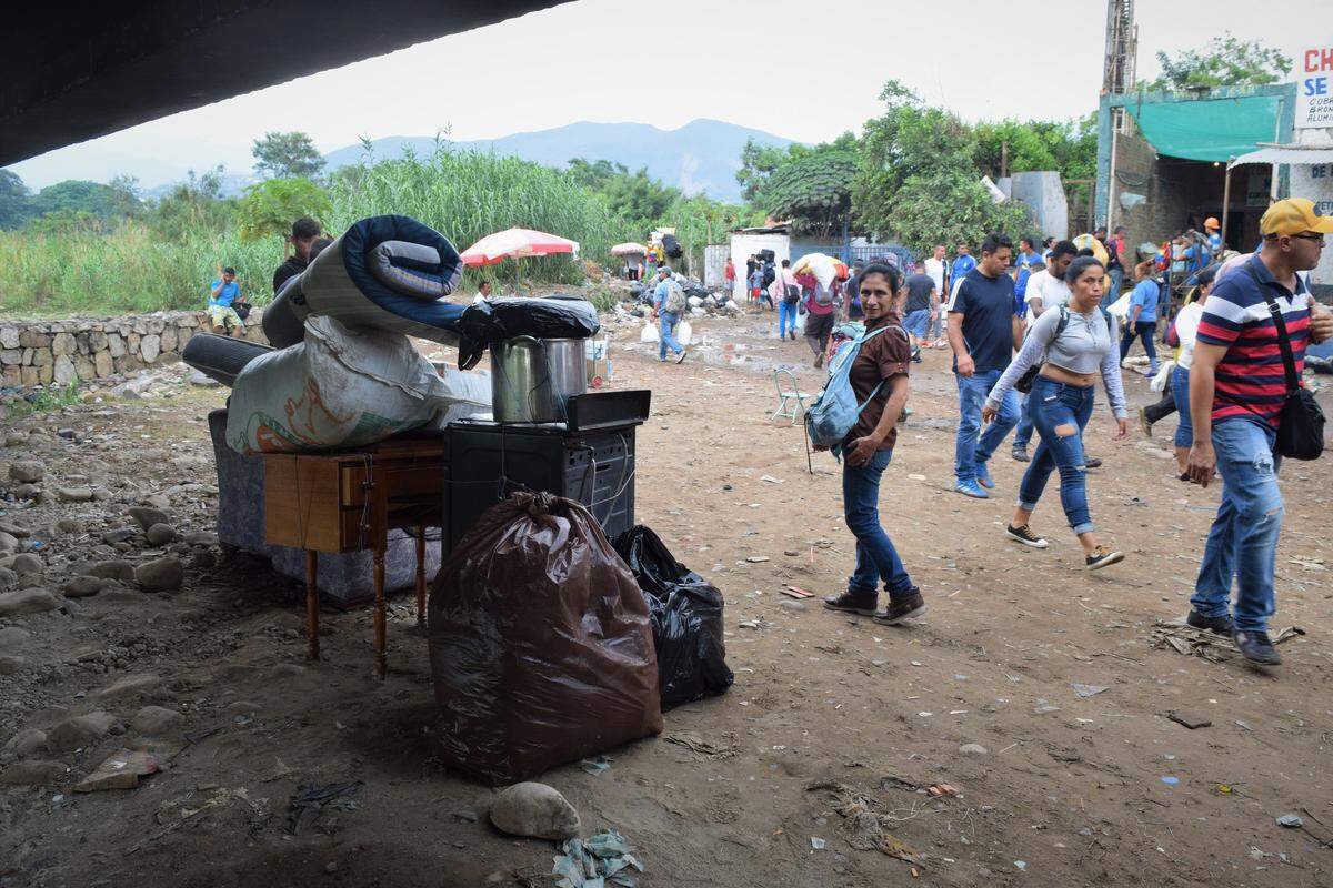 Laudelina Andrade, center, from San Cristobal, Venezuela, watches over furniture that she’s bringing into Colombia along an informal trail near Cúcuta, Colombia. Andrade said power outages, lack of water and hyperinflation have made it impossible to live in Venezuela. In recent years, more than 3.5 million people have left the country, many of them to neighboring Colombia.