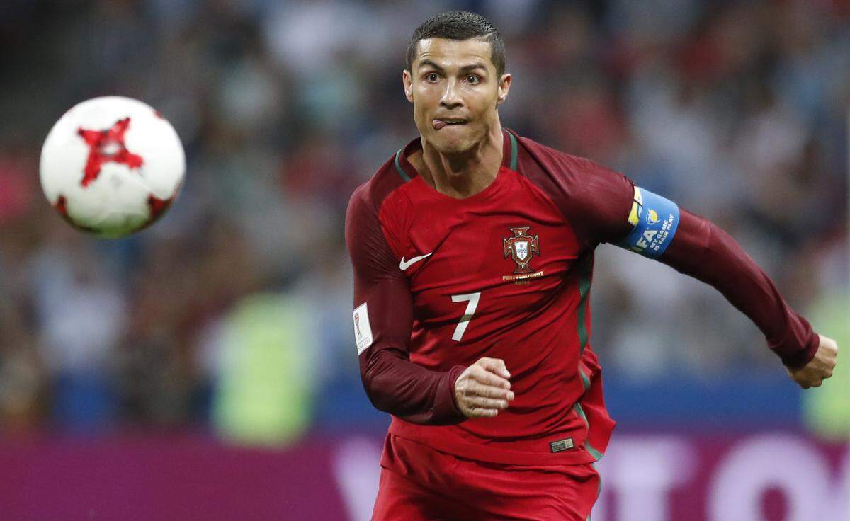 Portugal's Cristiano Ronaldo keeps his eyes on the ball during the Confederations Cup, semifinal soccer match between Portugal and Chile, at the Kazan Arena, Russia, Wednesday, June 28, 2017. (AP Photo/Pavel Golovkin)