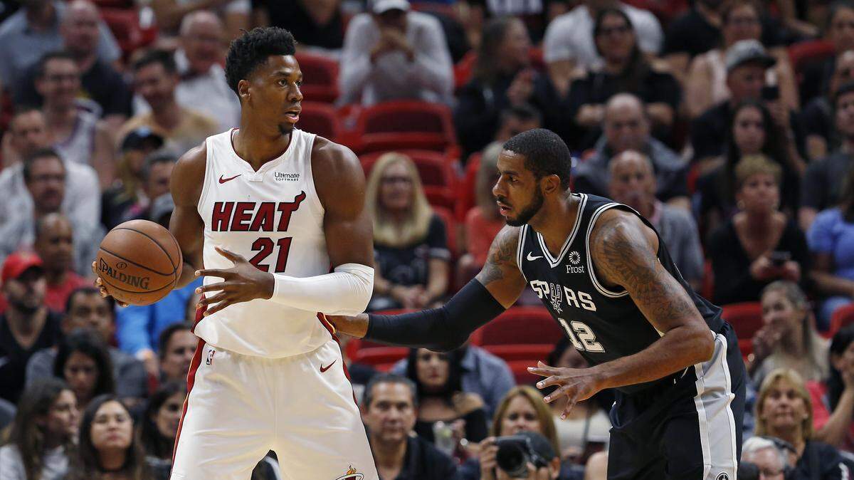 Miami Heat center Hassan Whiteside looks to pass against San Antonio Spurs forward LaMarcus Aldridge in the first quarter of an NBA basketball game at AmericanAirlines Arena on Wednesday, November 7, 2018 in Miami.