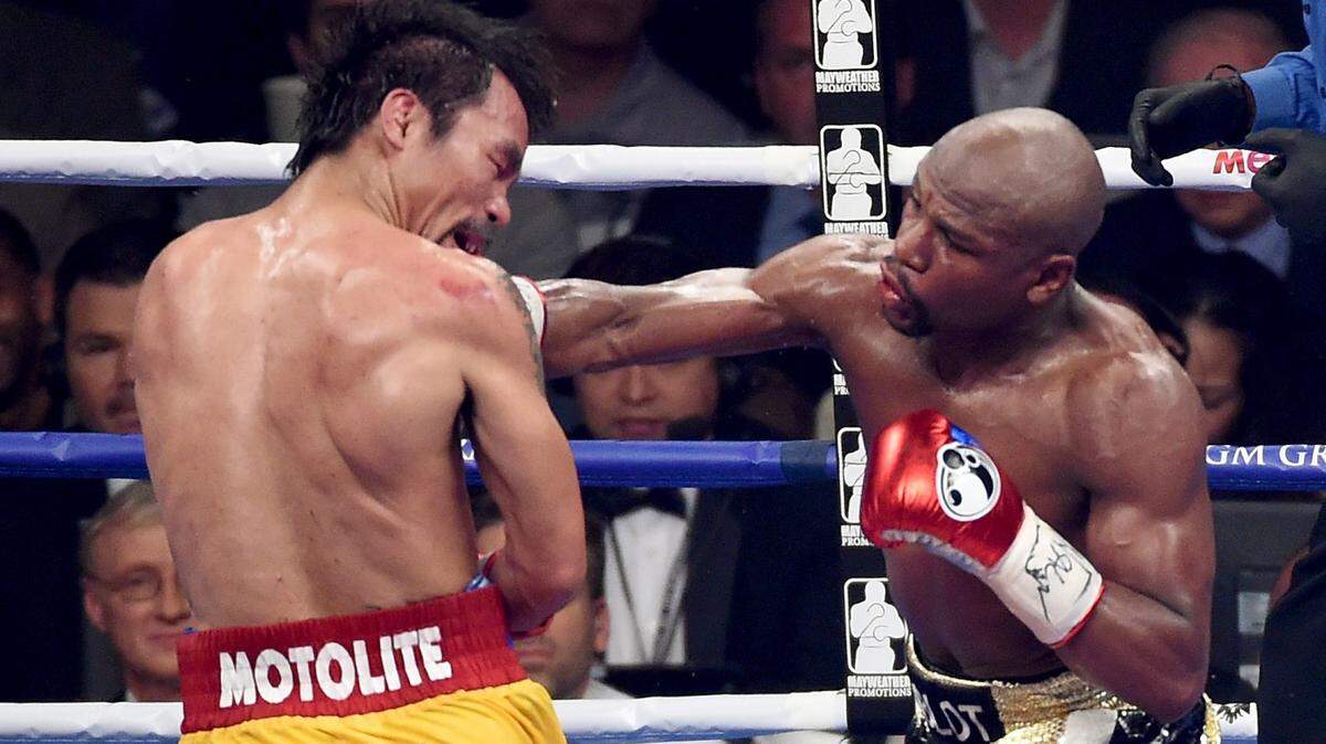 Floyd Mayweather Jr. throws a right at Manny Pacquiao during their welterweight unification championship bout on May 2, 2015 at MGM Grand Garden Arena in Las Vegas, Nevada.