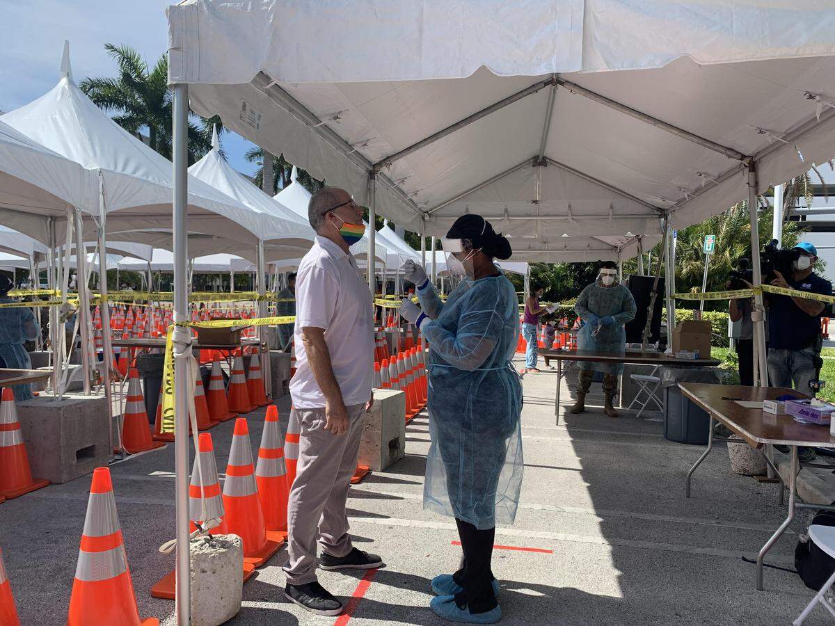 Miami Beach Mayor Dan Gelber receives a coronavirus test at the new walk-up and drive-thru testing center in South Beach, across from City Hall, on Thursday, May 7, 2020.