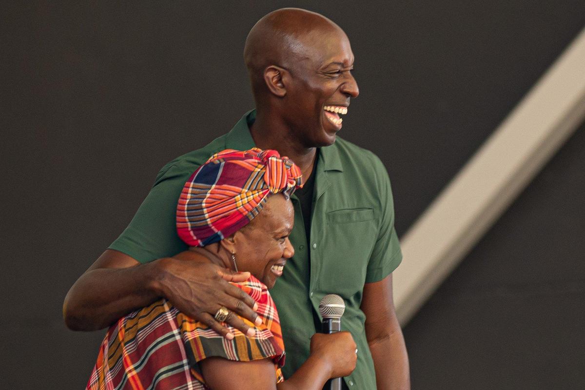 Miramar Mayor Wayne M. Messam (right) hugs author of “I am Jamaica” Dr. Sue on stage during the Jamaica Emancipendence Ole Time Fair at Miramar Regional Park Amphitheater in Miramar, Florida on Saturday, August 6, 2022. The free family-friendly event included kids trampolines, farmers market and dancing in celebration of Jamaica’s 60th Independence Anniversary.