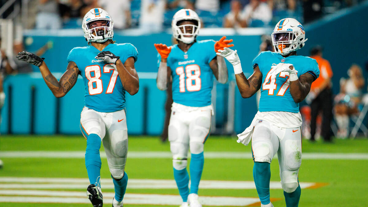 Miami Dolphins running back ZaQuandre White (47) celebrate with teammates Erik Ezukanma (87) and Preston Williams (18) after scoring a touchdown during fourth quarter of an NFL preseason football game against the Las Vegas Raiders at Hard Rock Stadium on Saturday, August 20, 2022 in Miami Gardens, Florida.