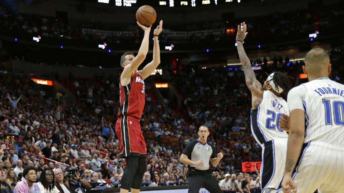 Heat forward Duncan Robinson (55) hits a three-pointer against Magic guard Markelle Fultz (20) in the fourth quarter of a March 4 game.
