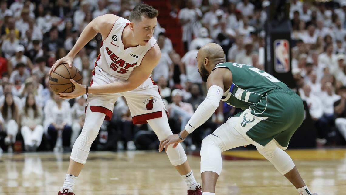 Miami Heat forward Duncan Robinson (55) protects the ball from Milwaukee Bucks guard Jevon Carter (5) in the fourth quarter during game three of the 2023 NBA Playoffs at Kaseya Center.
