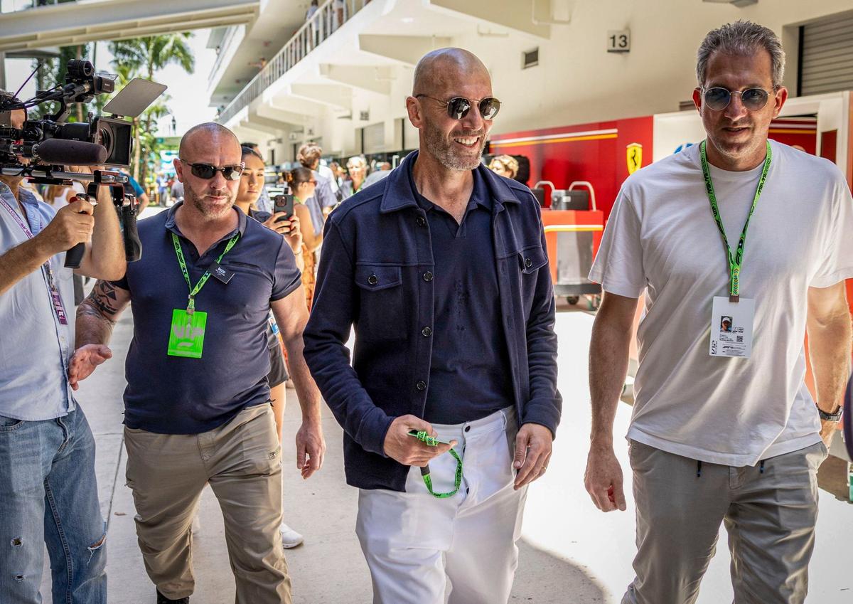 Former French football great Zinedine Zidane, center, walks along the paddock during day two of Formula One Miami Grand Prix.