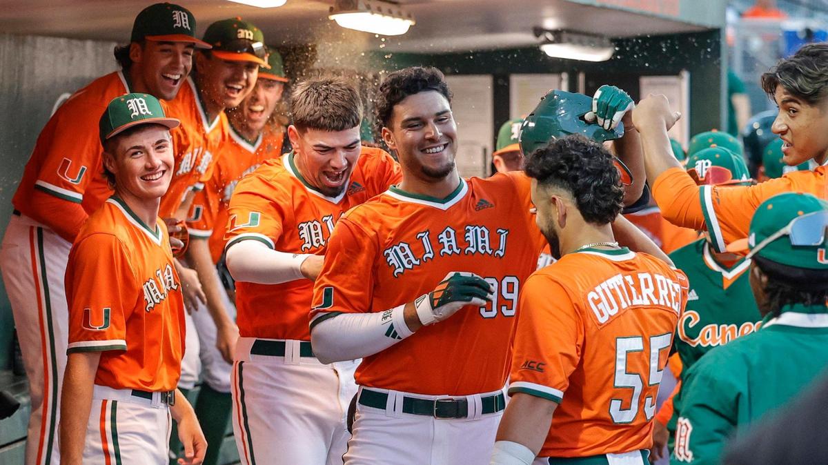 Miami Hurricanes outfielder Lorenzo Carrier (99) celebrates in the dugout with teammates after hitting a home run in the second inning against the North Carolina at Alex Rodriguez Park at Mark Light Field on campus in Coral Gables, Florida on Friday, March 15, 2024.
