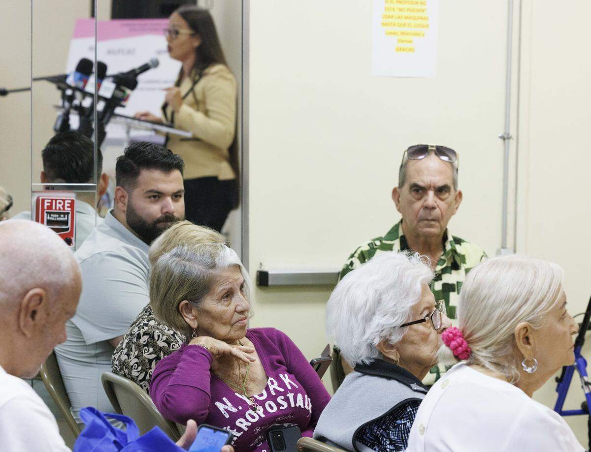 People listen as Hialeah Mayor Jacqueline Garcia-Roves speaks during a press conference about her proposal to lower property taxes for residents on Tuesday, Aug. 26, 2025, at Villa Aida Adult Center in Hialeah, Fla.