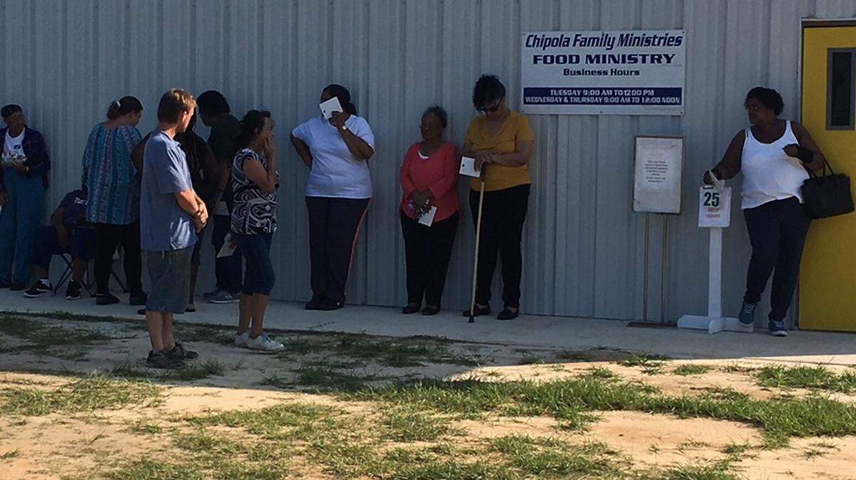 Unemployed people wait in line for free food at Chipola Family Ministries in Marianna. Each person is allowed one visit per month.