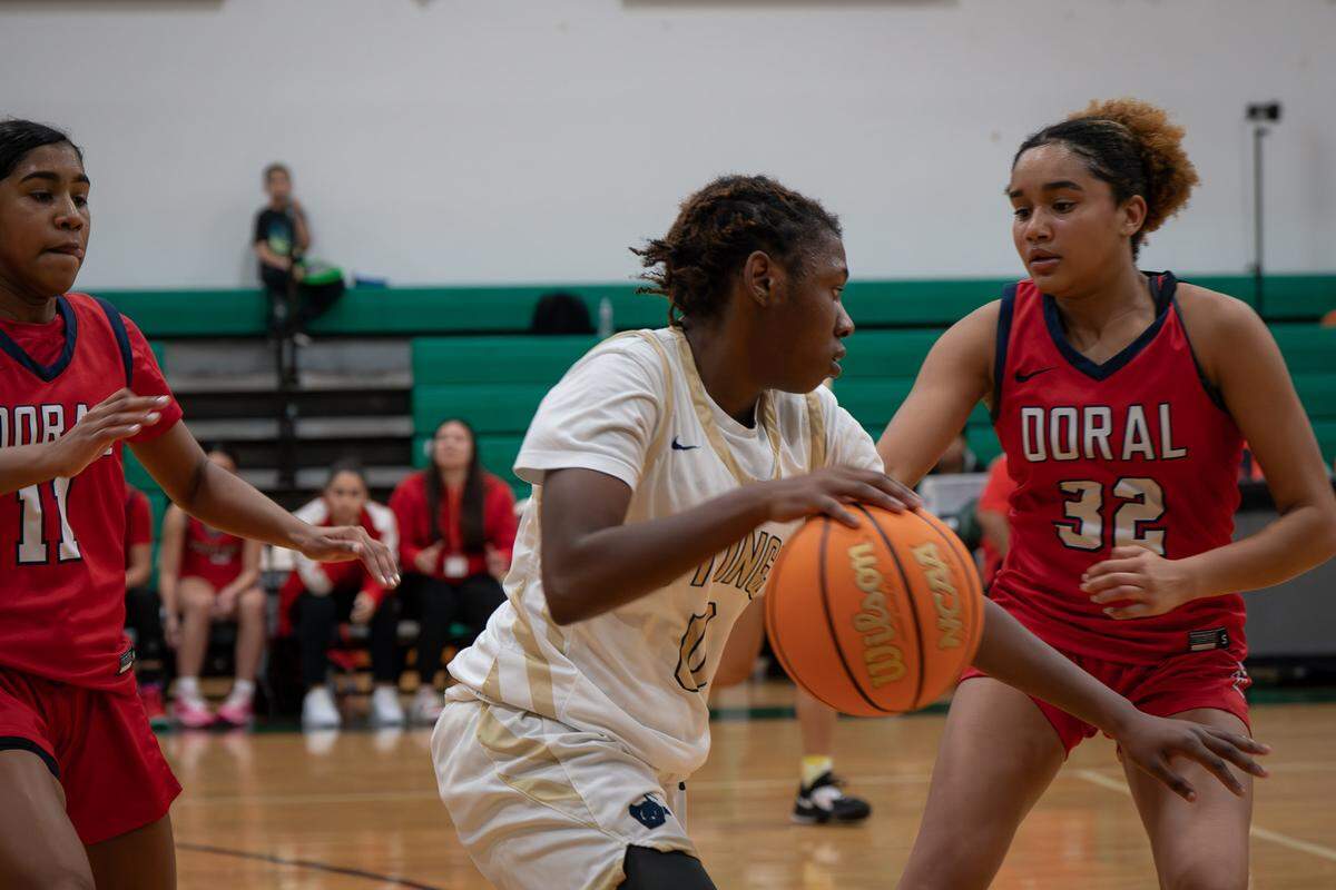 Miami High guard Jada Sinclair tries to work her way past Doral defender Victoria Valle during Saturday’s third place girls consolation game of the Junior Orange Bowl Baseball Classic at Westminster Christian.
