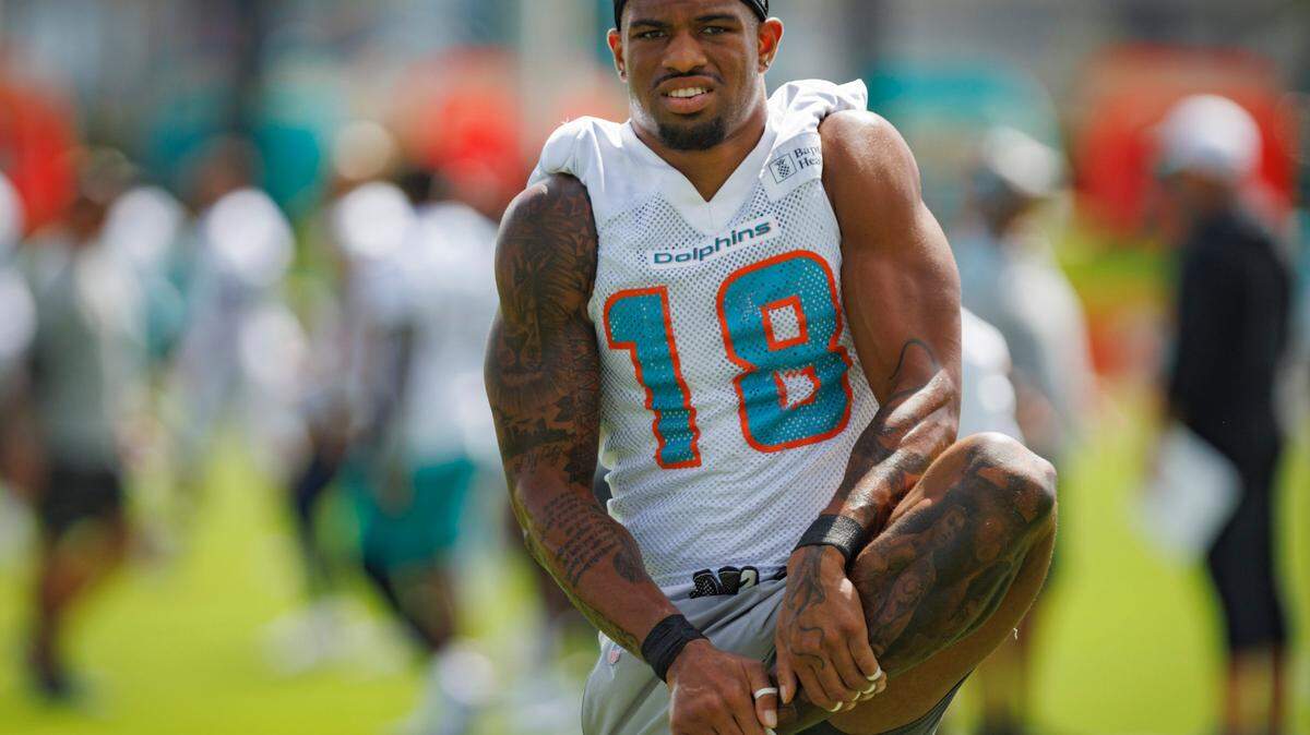 Miami Dolphin’s wide receiver Erik Ezukanma (18) stretches during Miami Dolphins training camp on Monday, Aug. 12, 2024, at Baptist Training Center at Hard Rock Stadium in Miami Gardens, Fla.