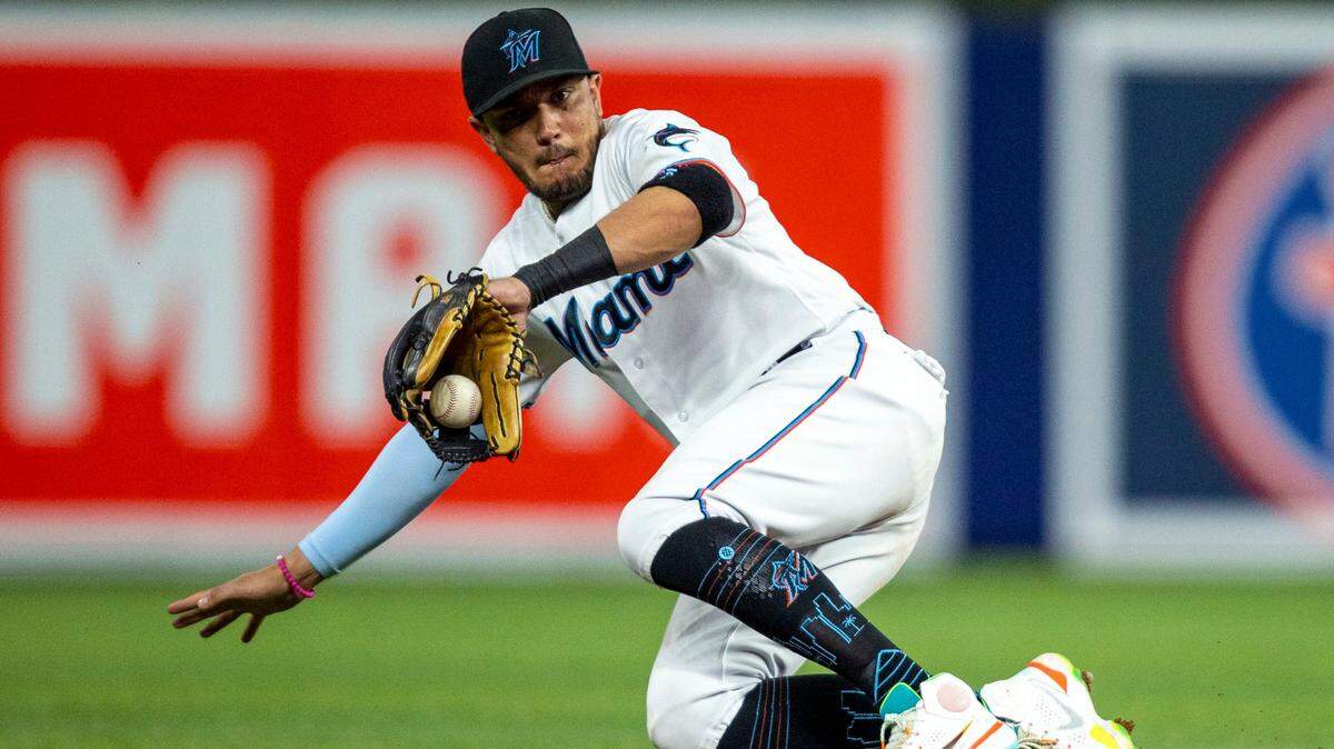 Miami Marlins shortstop Miguel Rojas (11) attempts to grab the ground ball before dropping it during the fourth inning of an MLB game against the Washington Nationals at loanDepot park in the Little Havana neighborhood of Miami, Florida, on Wednesday, June 8, 2022.