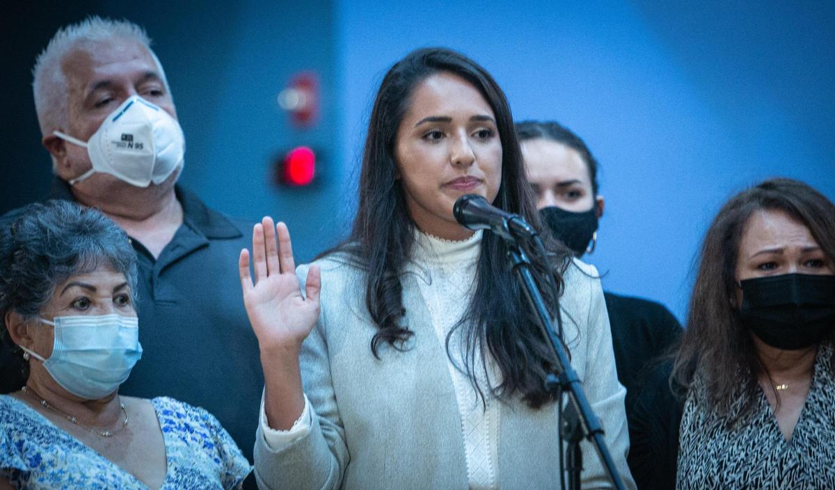 Surrounded by members of her family, newly elected member of the Miami-Dade School Board Luisa Santos, 30, an ice cream shop owner, is sworn in Tuesday.