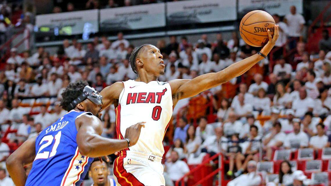 Heat small forward Josh Richardson leaps past Philadelphia 76ers center Joel Embiid for a basket in the first quarter in Game 4 of the first round of the NBA Playoffs at the AmericaneAirlines Arena in Miami, Florida, on April 21, 2018.