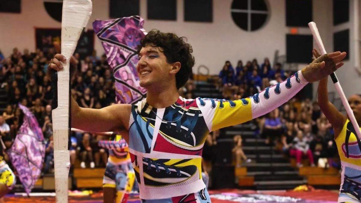 A West Broward High School student performs a color guard routine.