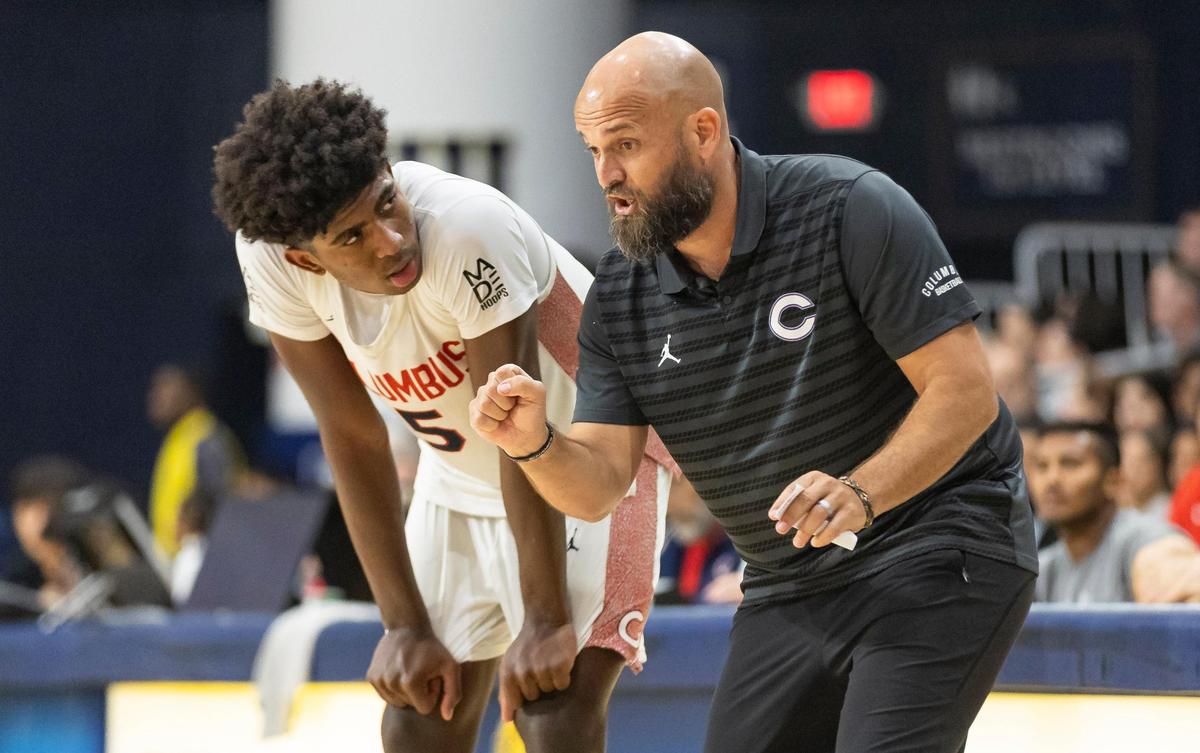 Columbus Explorers head coach Andrew Moran talks to Jaxon Richardson (5) as they play against the Miami High Stingarees in the second half of their Region 4-7A championship basketball game final at the Ocean Bank Convocation Center on Thursday, Feb. 20, 2025, in Miami, Fla.