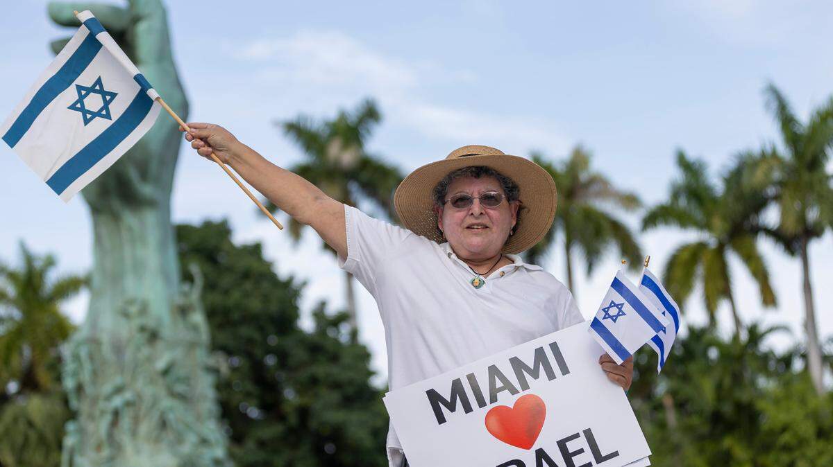 Doria Wosk, 65, from Kendall, waves the Israeli flag as people gathered for a rally at the Holocaust Memorial on Oct. 10 in Miami Beach. 