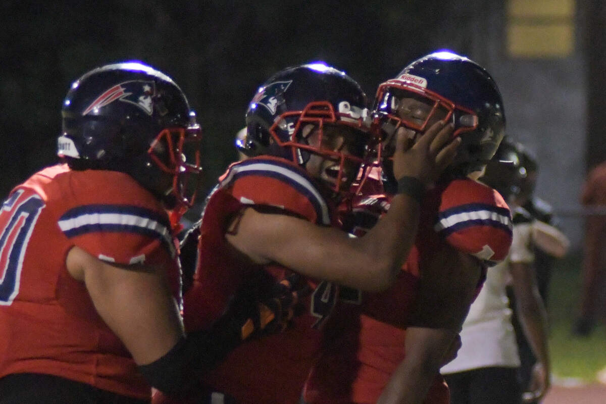 Miramar players celebrate with running back Nate Henry (right) after his go-ahead touchdown in the fourth quarter against Southridge on Friday, Nov. 18, 2022.