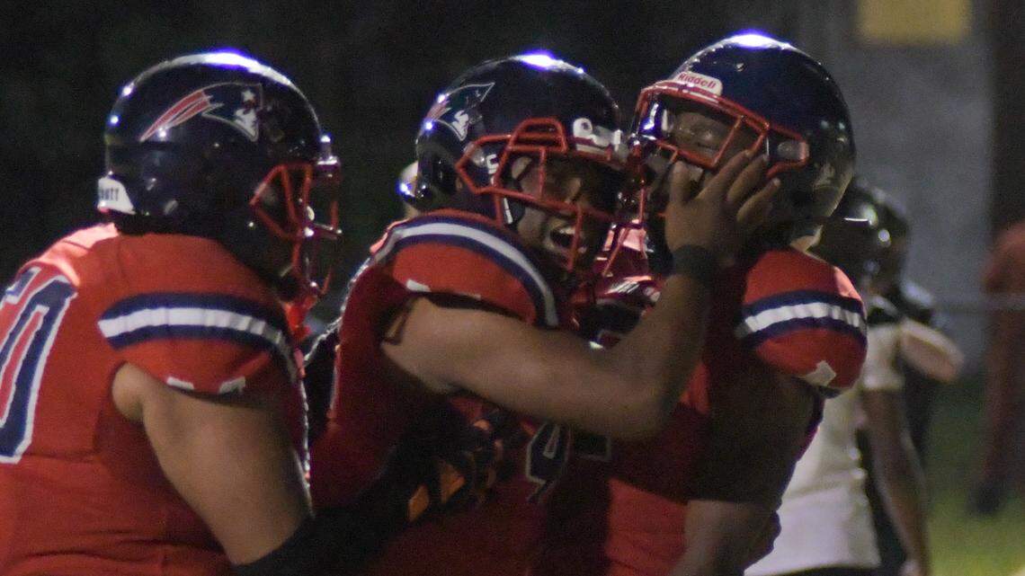 Miramar players celebrate with running back Nate Henry (right) after his go-ahead touchdown in the fourth quarter against Southridge on Friday, Nov. 18, 2022.